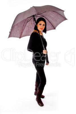 full body of young model holding umbrella