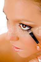 close up of female putting eye liner