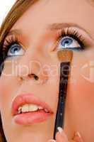 close view of woman putting eyeliner