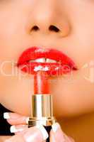close up of beautician applying lipsticks on woman's lips