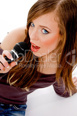 top view of woman singing into karaoke