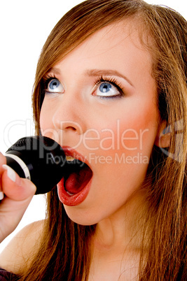 close view of woman singing into karaoke