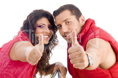 cheerful young couple showing thumbs up