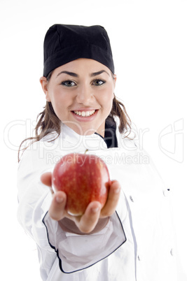 professional female chef showing fresh apple