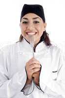 smiling female chef showing fork