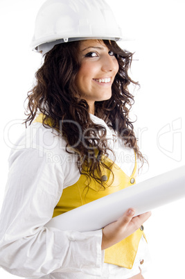 young female executive wearing hardhat and holding blueprints