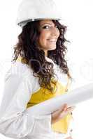 young female executive wearing hardhat and holding blueprints