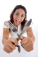 cute teenager showing cutlery