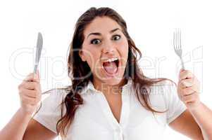 portrait of shouting woman with fork and knife