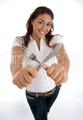 cute teenager showing cutlery