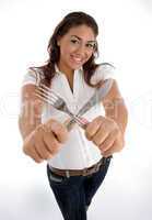 cute teenager showing cutlery