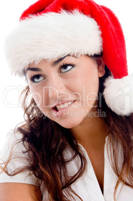 woman wearing christmas hat and looking upward