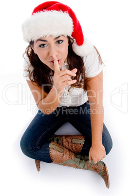 woman with christmas hat and asking to keep silent