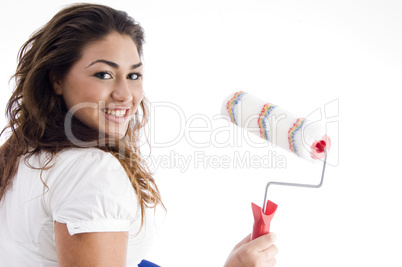 young female holding paint roller