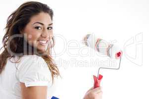 young female holding paint roller