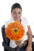 lovely girl showing orange gerbera flower