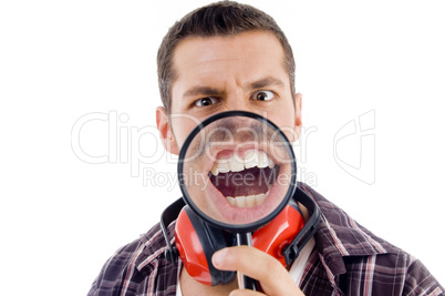 male showing teeth through magnifying glass