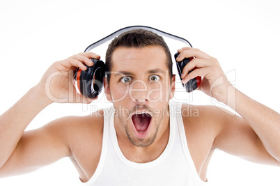astonished male listening music on headphone