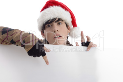 young boy wearing christmas hat indicating placard