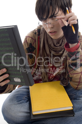 student posing with eyewear and books