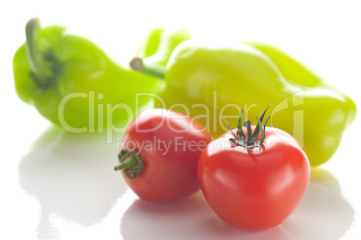 tomatoes and peppers isolated on white