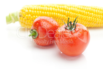 background of ripe yellow corn and tomato