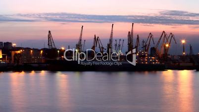 Silhouette of several cranes in a harbor, shot during sunset. Odessa, Ukraine
