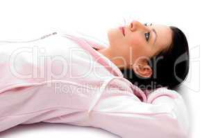 side view of laying woman looking upward on white background