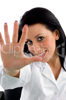 front view of smiling doctor showing palm on white background