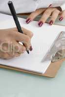 writing hands with notepad