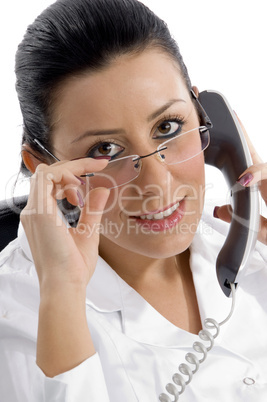portrait of female doctor holding receiver on white background