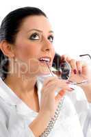 side pose of doctor talking on phone and looking upward on white background
