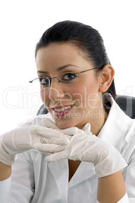 portrait of smiling doctor wearing hand gloves on white background