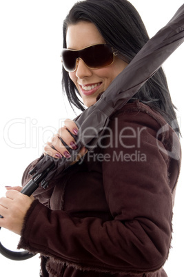 side view of female holding umbrella on white background