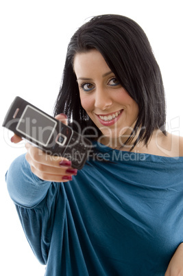 front view of smiling female showing mobile on white background
