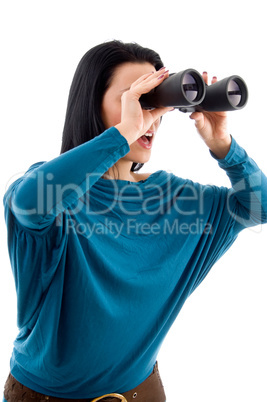 side pose of female looking through binocular on white background