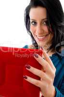 close view of pleased woman holding case on white background