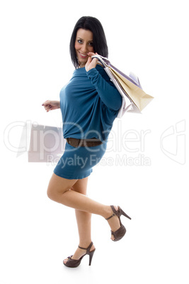 side pose of smiling model holding carry bags