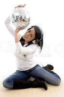 front view of smiling woman showing disco ball