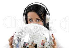 portrait of woman listening music and carrying disco ball