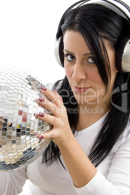 portrait of serious woman with disco ball and headphone