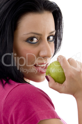 side pose of smiling female eating apple