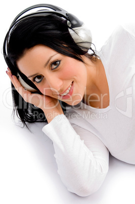 top view of smiling female listening music on white background