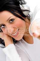 top view of pointing female enjoying music on an isolated white background