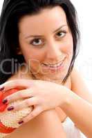top view of smiling woman scrubbing her body against white background
