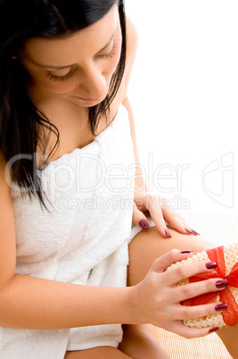 top view of woman scrubbing her body with white background