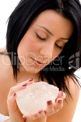 portrait of woman holding stone on an isolated background