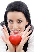 model holding small red heart