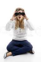 young female watching into binoculars