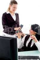 executive taking phone receiver from her secretary